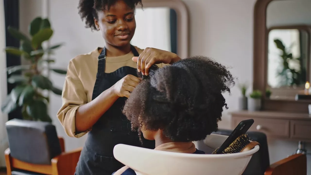 Illustrative hairdresser styling a client in a salon